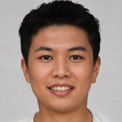 Joyful asian young-adult male with short  black hair and brown eyes