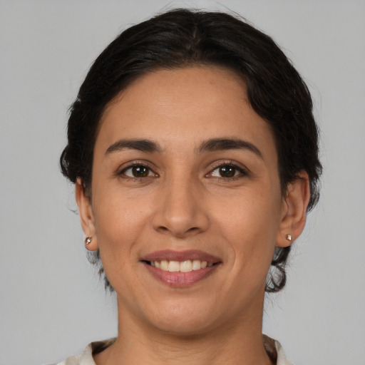 Joyful white young-adult female with medium  brown hair and brown eyes