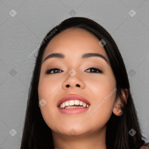 Joyful latino young-adult female with long  black hair and brown eyes