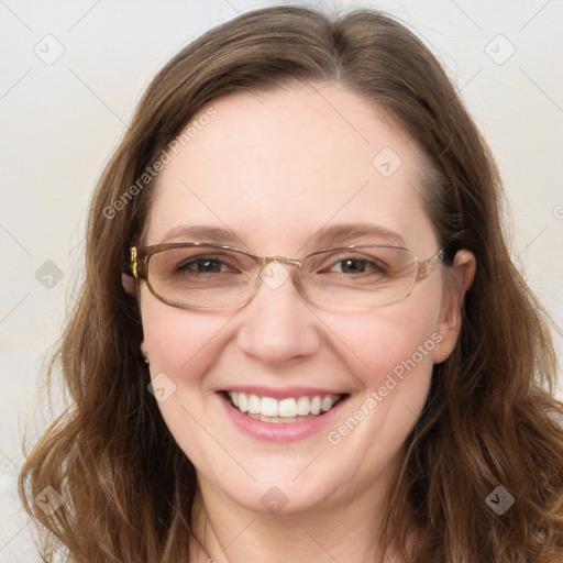 Joyful white adult female with long  brown hair and green eyes