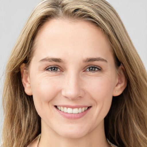 Joyful white young-adult female with long  brown hair and grey eyes