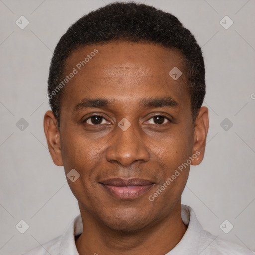 Joyful black young-adult male with short  black hair and brown eyes