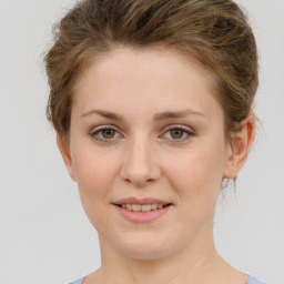 Joyful white young-adult female with short  brown hair and green eyes