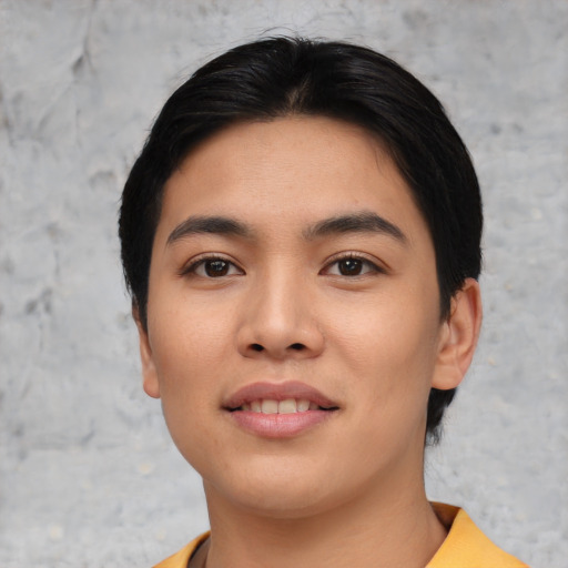 Joyful asian young-adult female with short  black hair and brown eyes