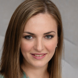 Joyful white young-adult female with long  brown hair and green eyes