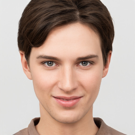 Joyful white young-adult female with short  brown hair and grey eyes