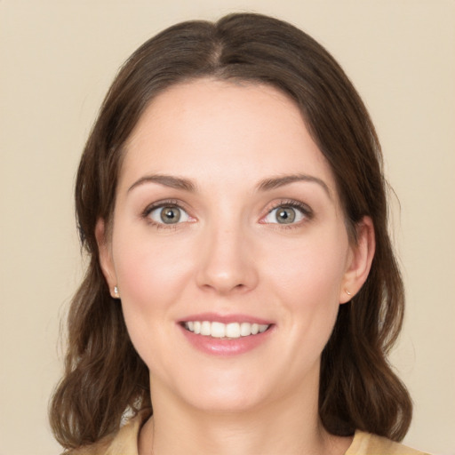 Joyful white young-adult female with medium  brown hair and green eyes