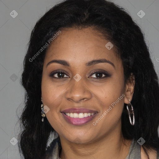 Joyful black adult female with long  brown hair and brown eyes