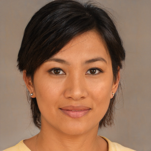 Joyful asian young-adult female with medium  brown hair and brown eyes