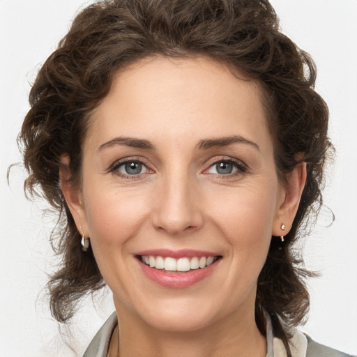 Joyful white young-adult female with medium  brown hair and green eyes