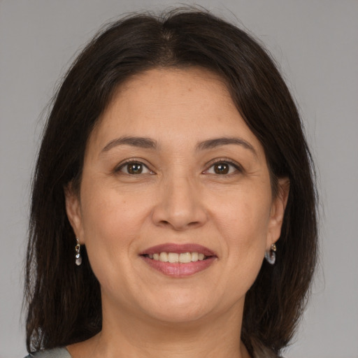 Joyful white adult female with medium  brown hair and brown eyes