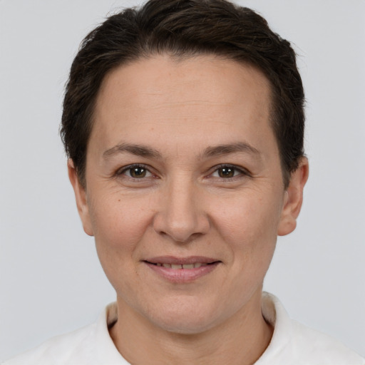 Joyful white adult female with short  brown hair and brown eyes