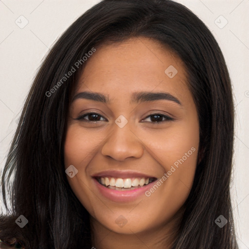 Joyful latino young-adult female with long  brown hair and brown eyes