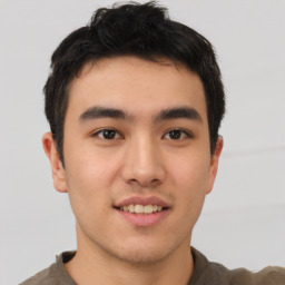 Joyful asian young-adult male with short  brown hair and brown eyes