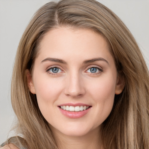 Joyful white young-adult female with long  brown hair and grey eyes