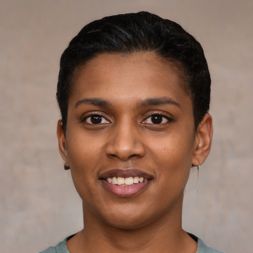 Joyful latino young-adult female with short  black hair and brown eyes