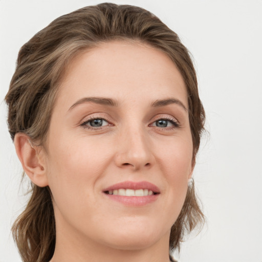 Joyful white young-adult female with medium  brown hair and green eyes