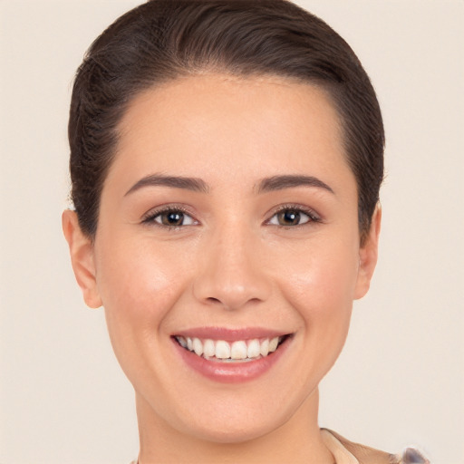 Joyful white young-adult female with short  brown hair and brown eyes