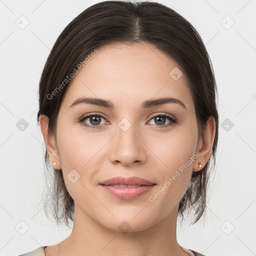 Joyful white young-adult female with medium  brown hair and grey eyes