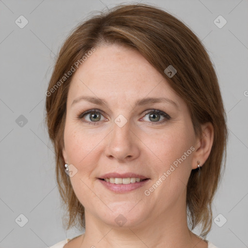 Joyful white adult female with medium  brown hair and grey eyes