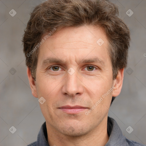 Joyful white adult male with short  brown hair and grey eyes