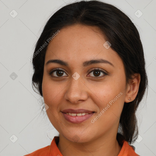 Joyful latino young-adult female with medium  brown hair and brown eyes