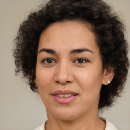 Joyful latino adult female with medium  brown hair and brown eyes