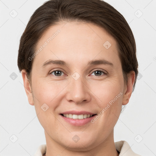 Joyful white young-adult female with short  brown hair and grey eyes