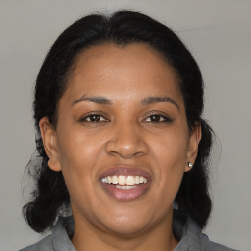 Joyful black young-adult female with medium  black hair and brown eyes