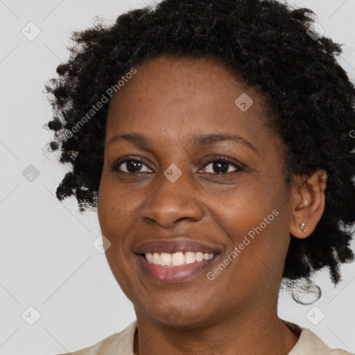 Joyful black adult female with medium  brown hair and brown eyes