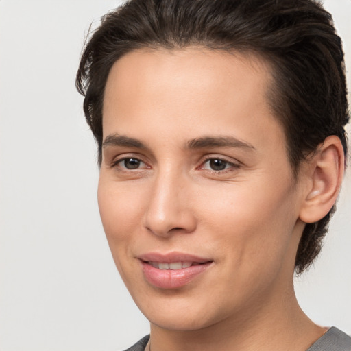 Joyful white young-adult female with short  brown hair and brown eyes