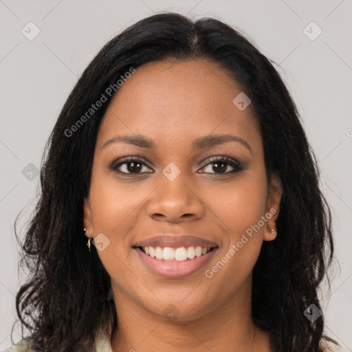 Joyful black young-adult female with long  brown hair and brown eyes