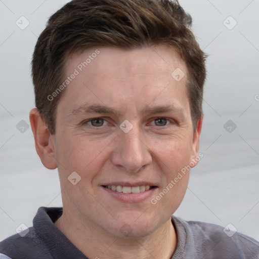 Joyful white adult male with short  brown hair and grey eyes