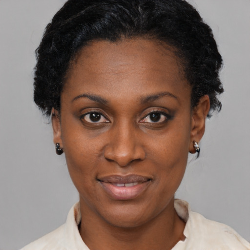 Joyful latino young-adult female with short  black hair and brown eyes