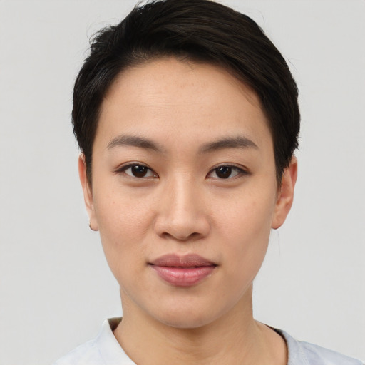 Joyful asian young-adult female with short  black hair and brown eyes