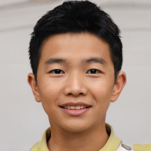 Joyful asian child male with short  black hair and brown eyes