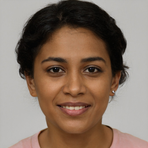 Joyful latino young-adult female with short  brown hair and brown eyes