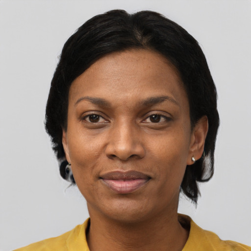 Joyful black adult female with short  black hair and brown eyes
