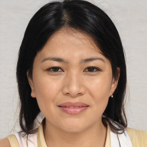 Joyful asian young-adult female with medium  brown hair and brown eyes