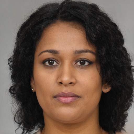Neutral black young-adult female with long  brown hair and brown eyes