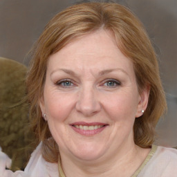 Joyful white adult female with medium  brown hair and blue eyes