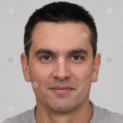 Joyful white young-adult male with short  black hair and brown eyes