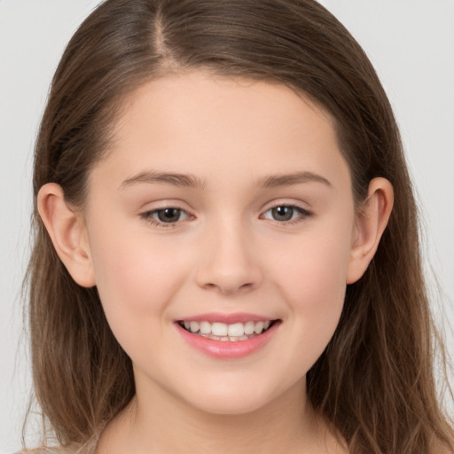 Joyful white child female with long  brown hair and brown eyes