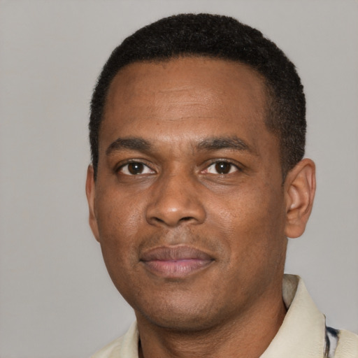 Joyful black young-adult male with short  black hair and brown eyes