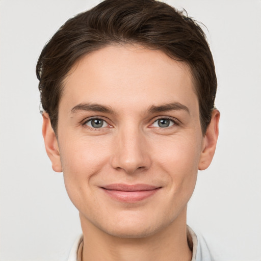 Joyful white young-adult female with short  brown hair and grey eyes