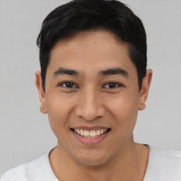 Joyful asian young-adult male with short  black hair and brown eyes