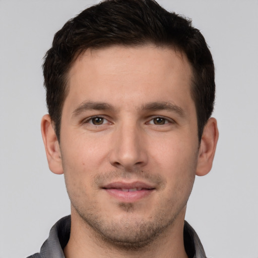 Joyful white young-adult male with short  brown hair and brown eyes