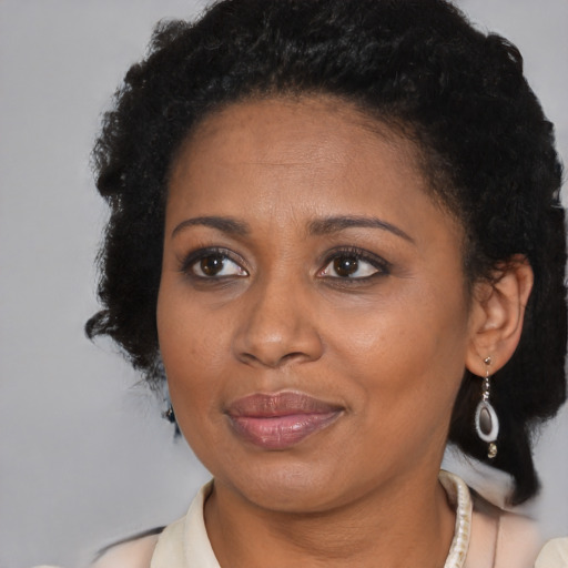Joyful black adult female with short  brown hair and brown eyes
