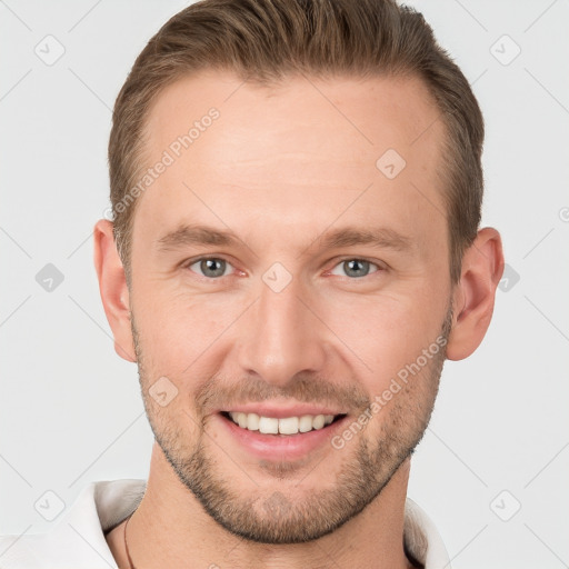 Joyful white young-adult male with short  brown hair and grey eyes