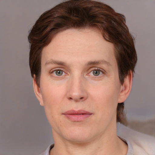 Joyful white adult female with short  brown hair and brown eyes